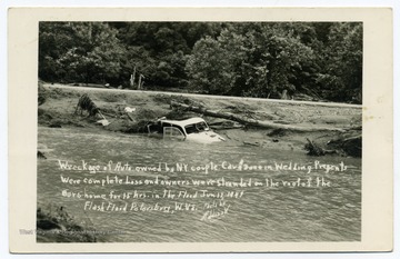 Text reads, "Wreckage of auto owned by N. Y. couple. Car and $3000 of wedding presents were complete loss and owners were stranded on the roof of the Ours home for 15 hours in the Flood June 17 1949. Flash flood, Petersburg, W. Va."