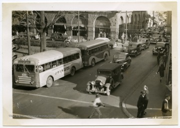 Caption reads: "Pike Street, US 50 looking East from intersection of South Fourth Street. Shows bus loading. Some buses make left turn here from loading platform on right side of Pike Street." 