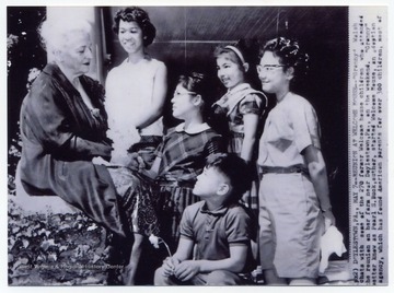 Caption reads: "Doylestown, PA., May 7 - Reunion at Welcome House - 'Granny' Walsh chats with some of the 270 former Welcome House children who attended the reunion on her farm near Doylestown, Pa., on the weekend. 'Granny,' better known as Pearl S. Buck, author, started Welcome House, an adoption agency, which has found American parents for over 300 children..."