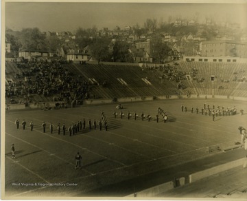 The band forms the WVU letters on the football field. 