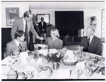 Rene Henry is talking with Olympic skier Cindy Nelson and President Gerald Ford in Vail, Colorado during a special event luncheon.