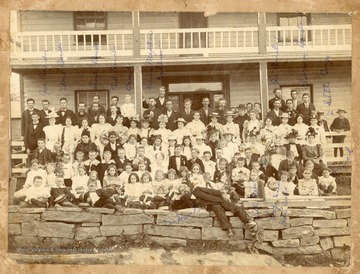 Reverend Hank lies in the forefront of the photo.Other persons identified in the photo include:Joe Deeds (back row, second from left)Alva Deeds (back row, third from left)Charles Deeds (back row, fifth from left)Bob Deeds (back row, sixth from left)Basil Abshire (back row, seventh from left)Green Meadow (back row, eighth from left)Dobbins (back row, middle, has hand on banister)J.A. Deeds (back row, third from right)Clarence Deeds (back row, first on right)Virgie Deeds (front row, fourth from right)Grace Deeds (front row, third from right)