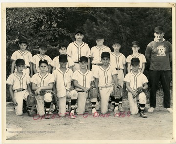 The manager, "Jumbo" Ponciroff, alongside the players of the 1968 "Oates Tel-O Dine" Little League baseball team.
