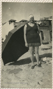 Ruby at a beach in a bathing suit.